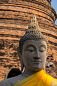 Ayutthaya, Thailand. Wat Yai Chai Mongkhon, saffron-draped Buddha statues inside the temple compound. 